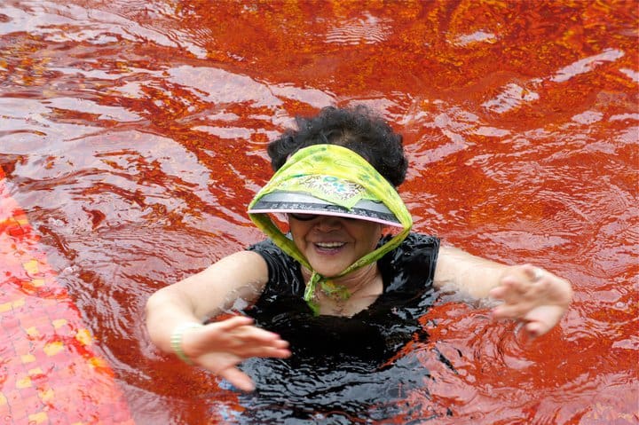 ajumma in visor swimming in red pool