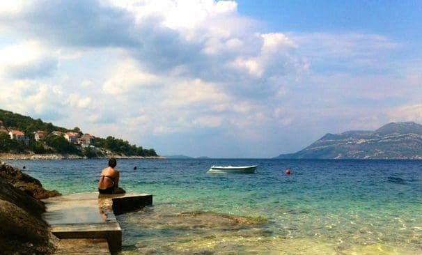 girl sitting on dock on badija island