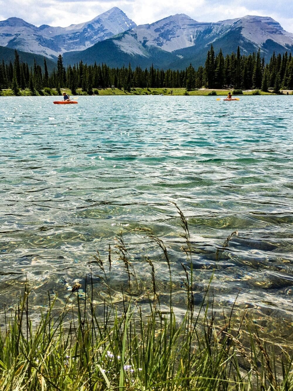 The Unforgettable, Forget-Me-Not Pond in Kananaskis 4 people paddling on forget me not pond in alberta