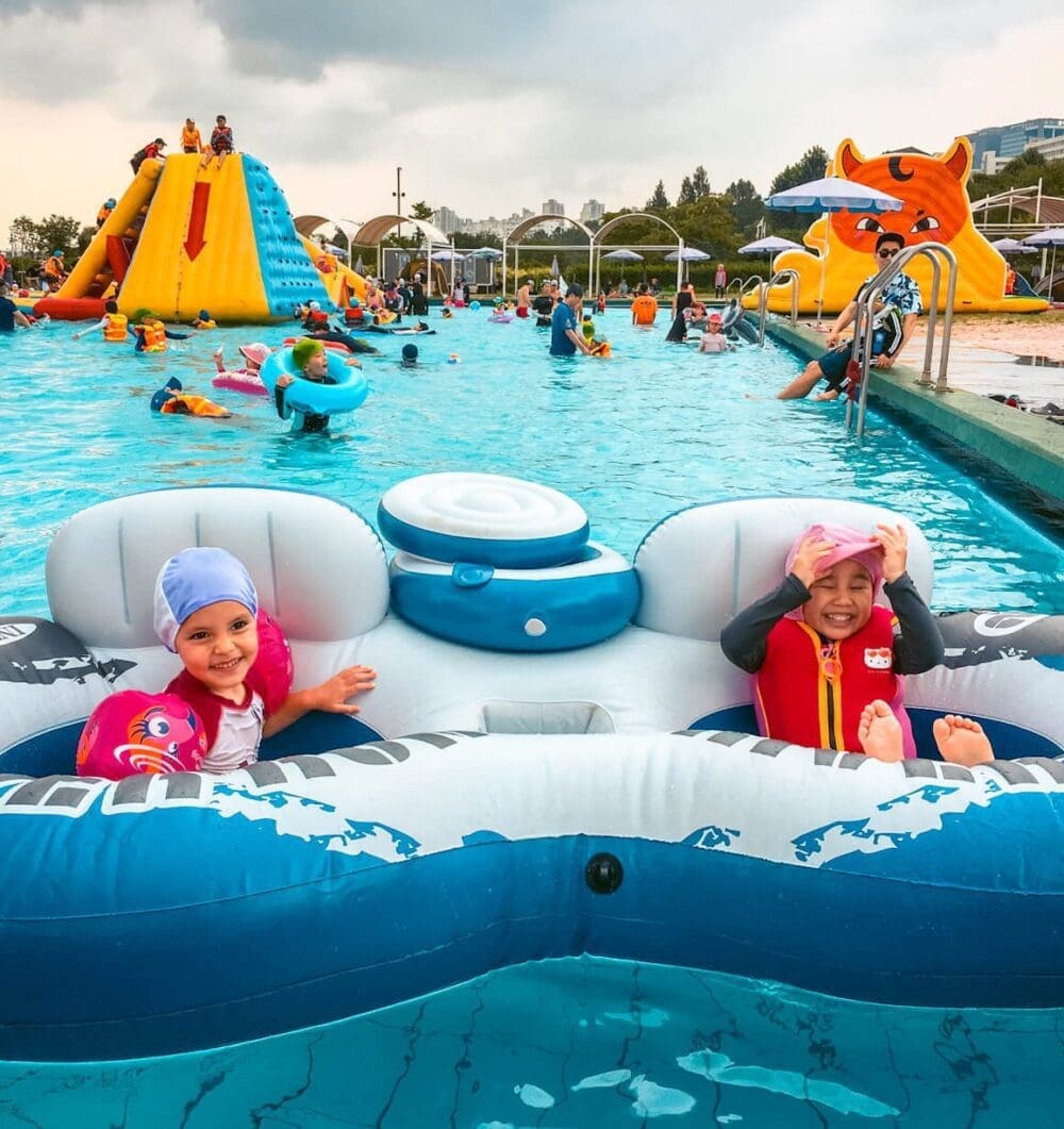 Summer in Korea 2026 | 43 Awesome Activities and Fun Festivals to Enjoy 30 kids playing inside a han river park swimming pool during summer in korea