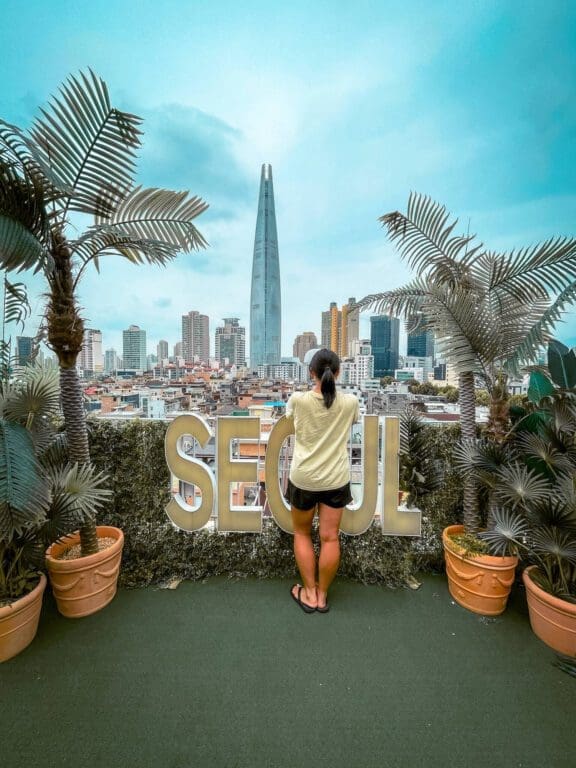 rooftop of seoulism cafe with neon seoul sign