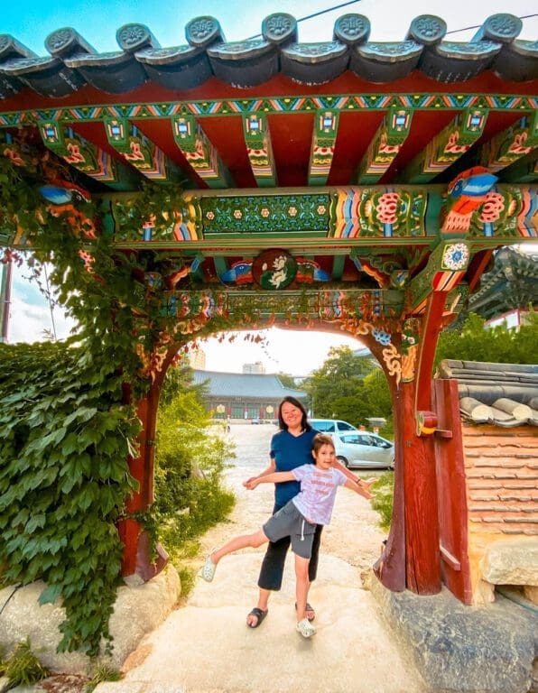 mom and daughter standing in front of a gate at Bongeunsa temple
