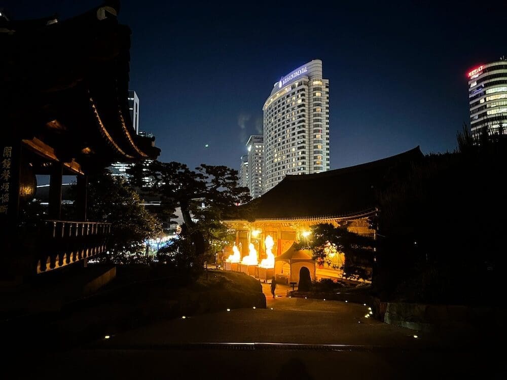 lanterns at bongeunsa temple at night with the intercontinental hotel in the background